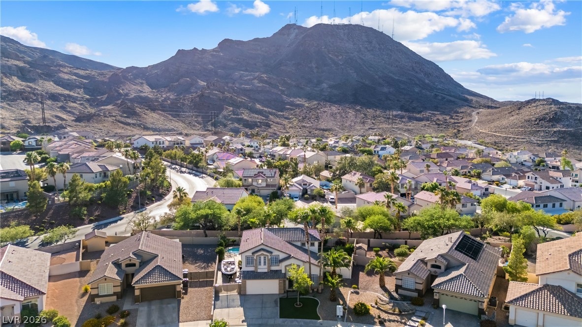 708 Vortex Avenue Henderson, NV 89002 - Photo 65 of 71 An aerial perspective reveals a vibrant neighborhood nestled against a majestic mountain backdrop.