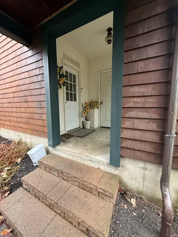 a view of a house with a door and wooden walls