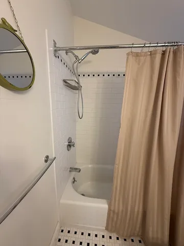 a bathroom with a shower and a bath tub