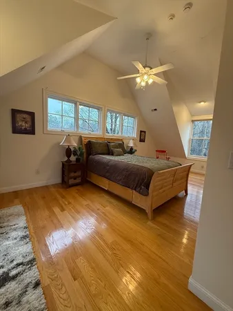 a living room with a bed furniture chandelier and a window