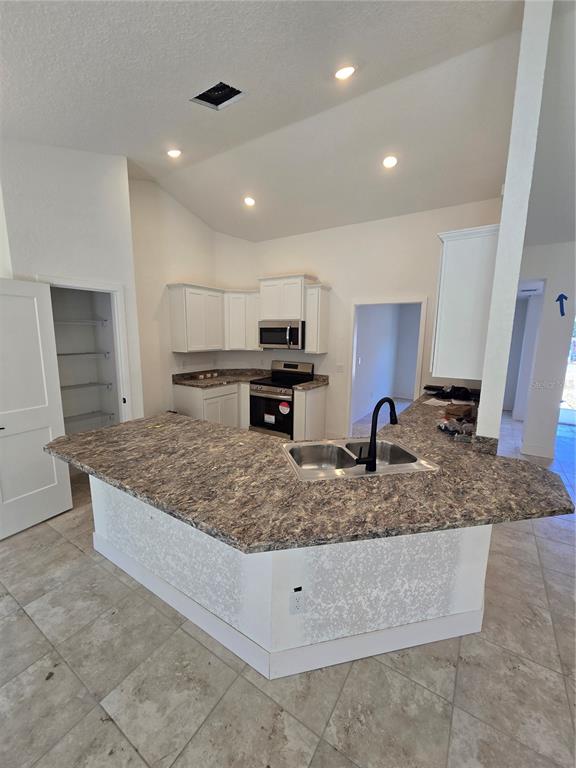 2533 Clearwood Street Inverness, FL 34452 - Photo 12 of 21 a kitchen with stainless steel appliances granite countertop a sink stove and refrigerator