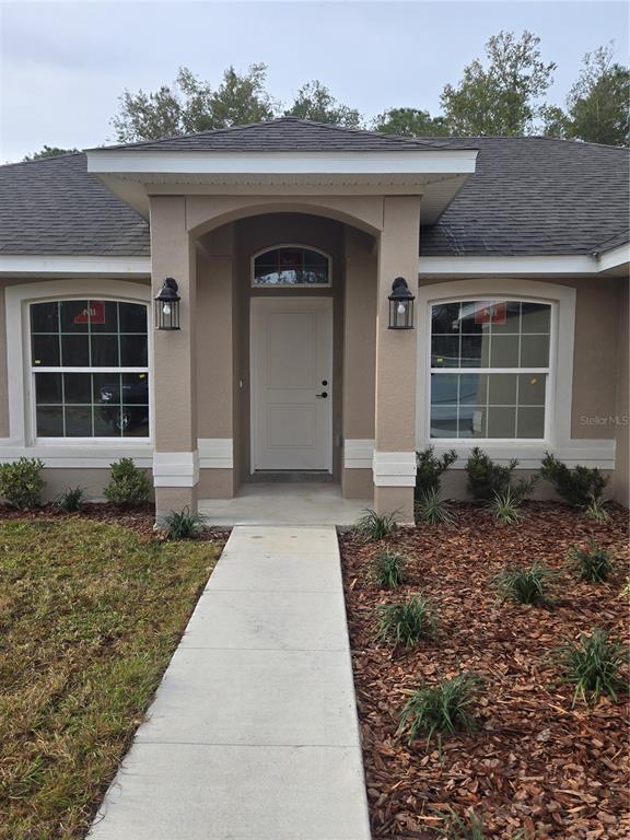 2533 Clearwood Street Inverness, FL 34452 - Photo 4 of 21 a front view of a house with garden