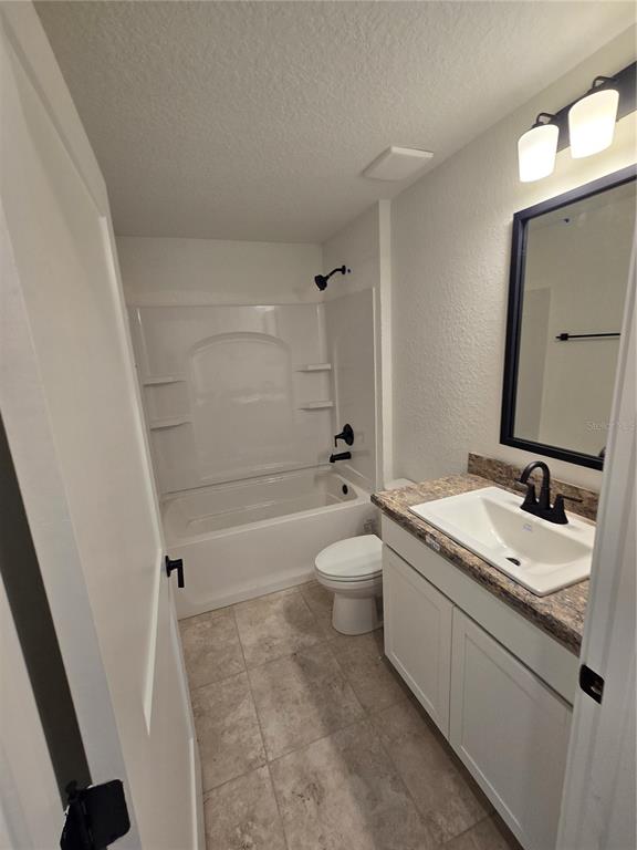 2533 Clearwood Street Inverness, FL 34452 - Photo 9 of 21 a bathroom with a granite countertop sink mirror vanity and toilet