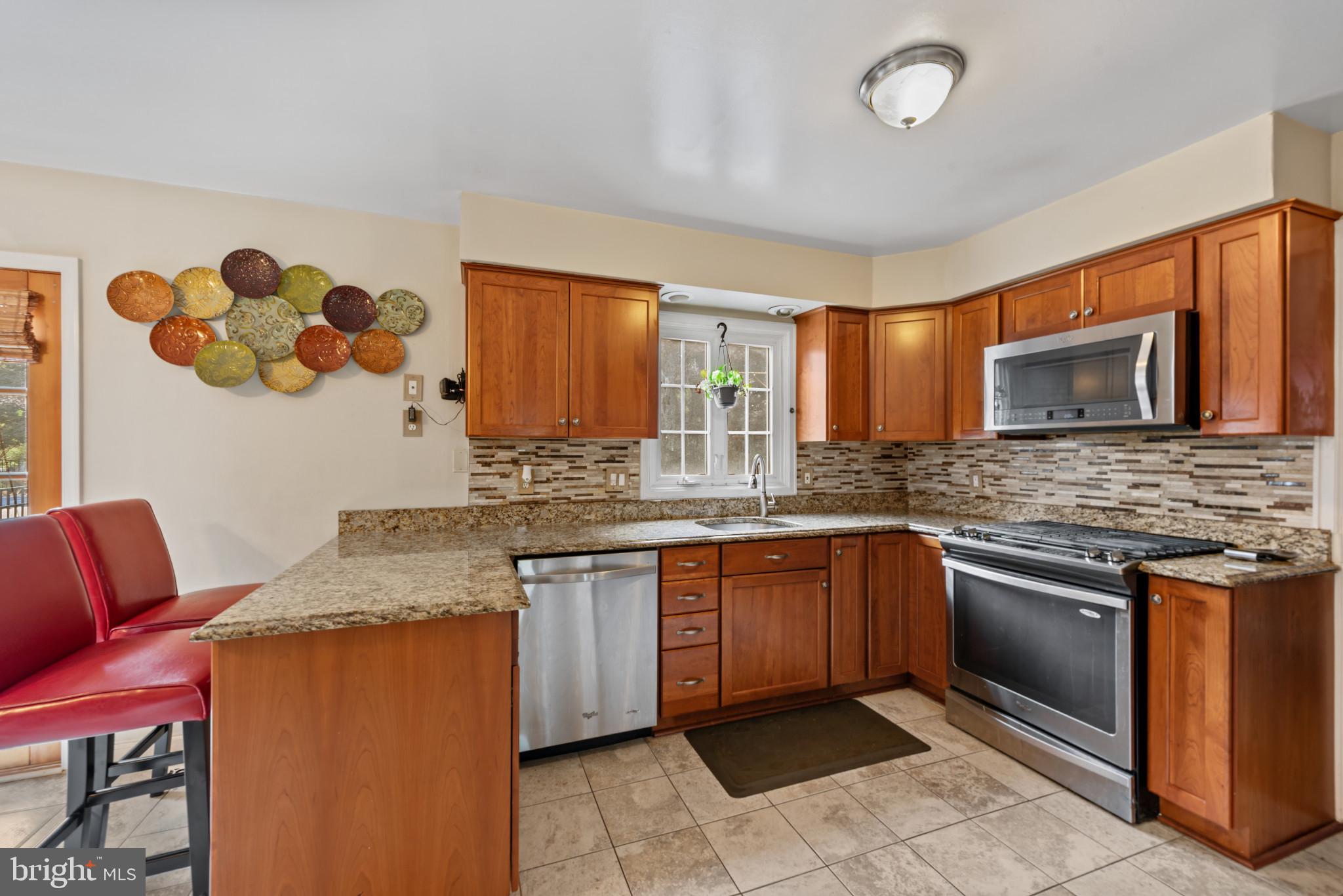 1309 Midmeadow Road Baltimore, MD 21286 - Photo 4 of 37 a kitchen with a sink stove and microwave