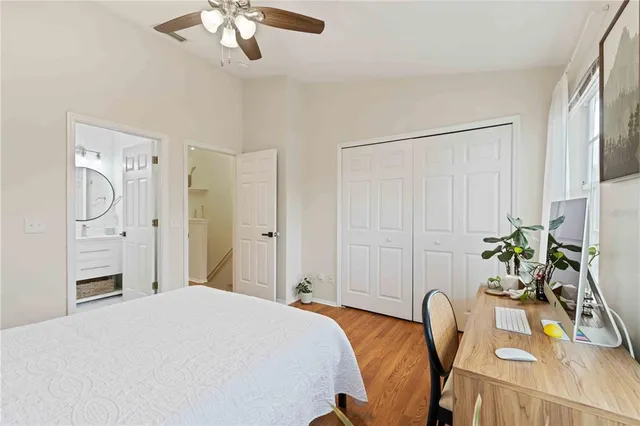 a bedroom with a bed chandelier and a window