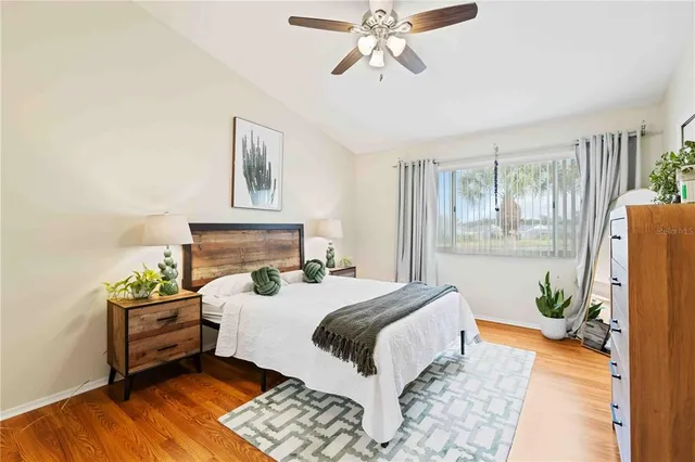 a bedroom with a bed and wooden floor