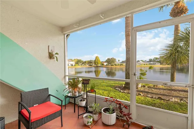 a view of a porch with furniture and a gate