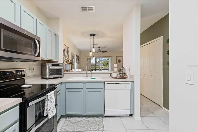 a kitchen with stainless steel appliances granite countertop a sink and stove top oven