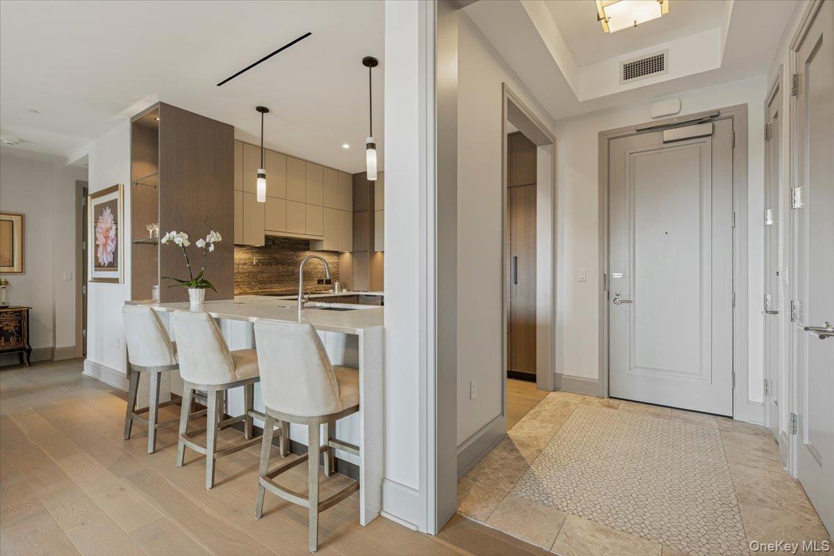 a dining room with furniture and a chandelier fan