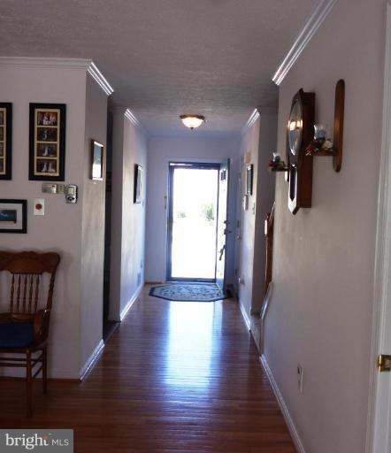 9229 Howland Road Laurel, MD 20723 - Photo 11 of 15 a view of hallway with stairs and wooden floor