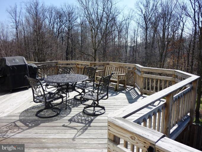 9229 Howland Road Laurel, MD 20723 - Photo 14 of 15 a view of balcony with wooden floor and outdoor seating