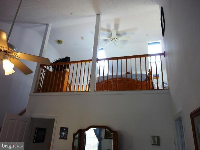 9229 Howland Road Laurel, MD 20723 - Photo 4 of 15 a view of staircase with railing and a rug
