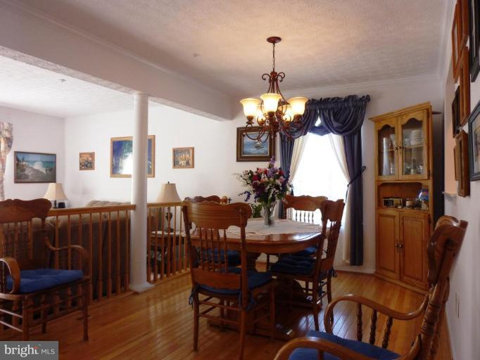 9229 Howland Road Laurel, MD 20723 - Photo 6 of 15 a view of a dining room with furniture window and wooden floor