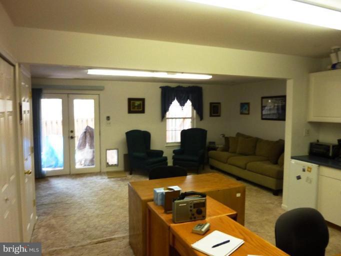 9229 Howland Road Laurel, MD 20723 - Photo 8 of 15 a living room with furniture and a fireplace