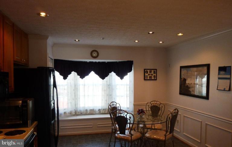 9229 Howland Road Laurel, MD 20723 - Photo 10 of 15 a view of a dining room with furniture window and wooden floor