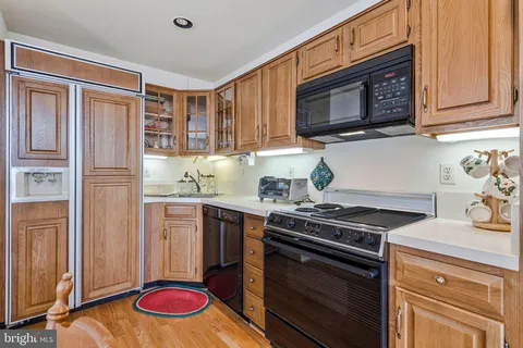 a kitchen with stainless steel appliances granite countertop a stove top oven microwave and cabinets