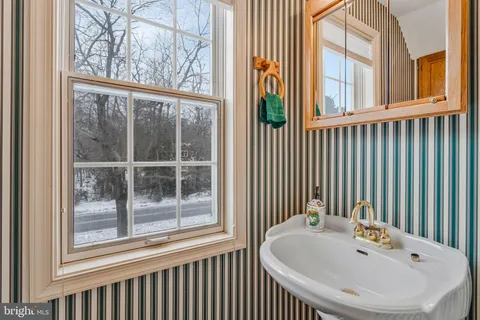a bathroom with a sink and a large window