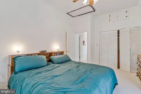 a bedroom with a bed and a lamp