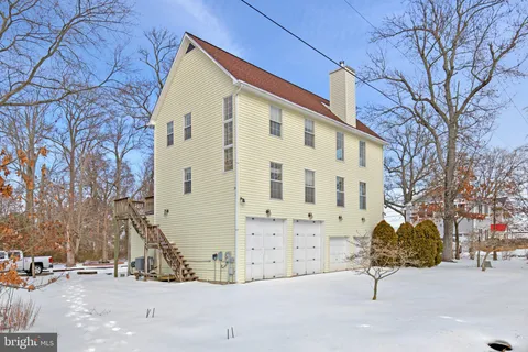 a view of a house with a snow in the background
