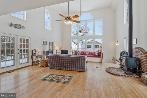 a living room with furniture gym equipment and a chandelier