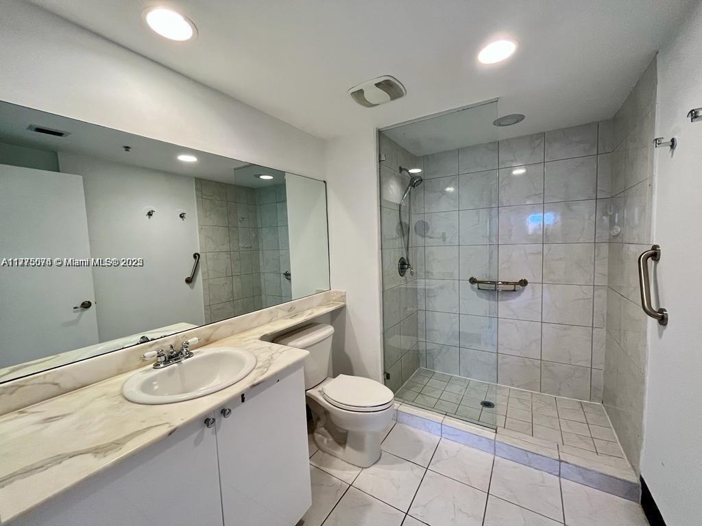2775 Northeast 187th Street, Unit 326 Aventura, FL 33180 - Photo 12 of 23 a bathroom with a sink a toilet and shower