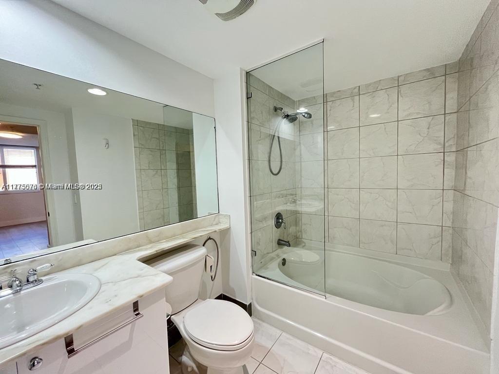 2775 Northeast 187th Street, Unit 326 Aventura, FL 33180 - Photo 13 of 23 a bathroom with a bathtub shower sink mirror and toilet