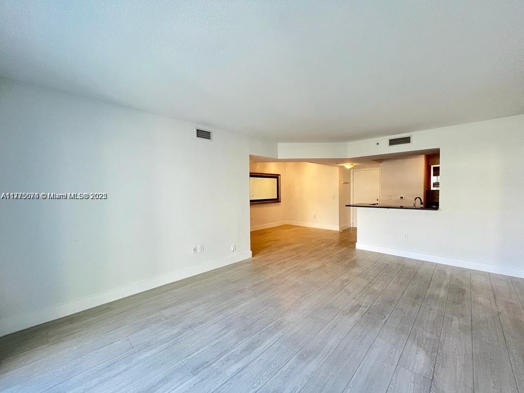 2775 Northeast 187th Street, Unit 326 Aventura, FL 33180 - Photo 17 of 23 a view of an empty room with wooden floor and a window