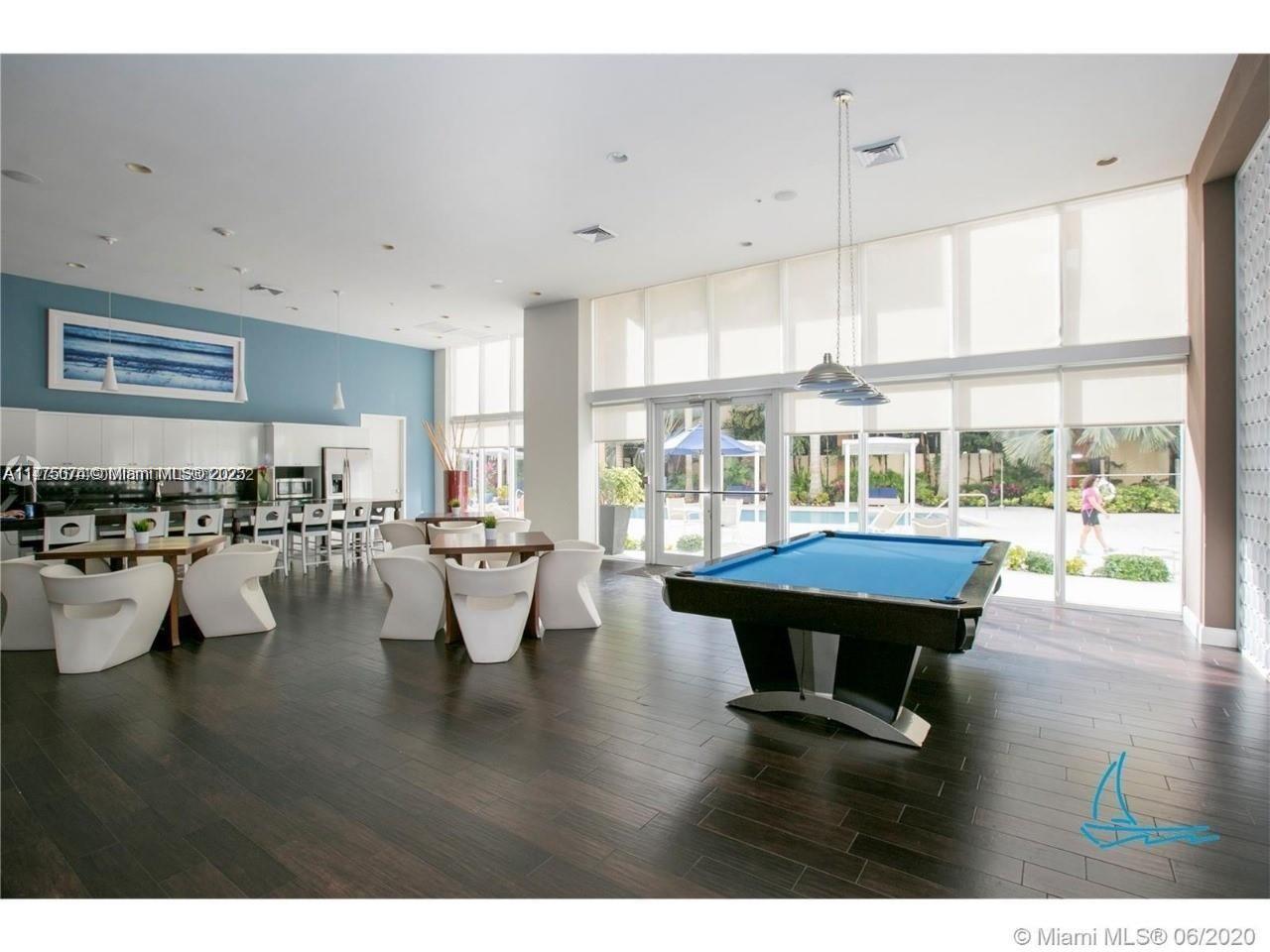 2775 Northeast 187th Street, Unit 326 Aventura, FL 33180 - Photo 21 of 23 a living room with furniture and a large window