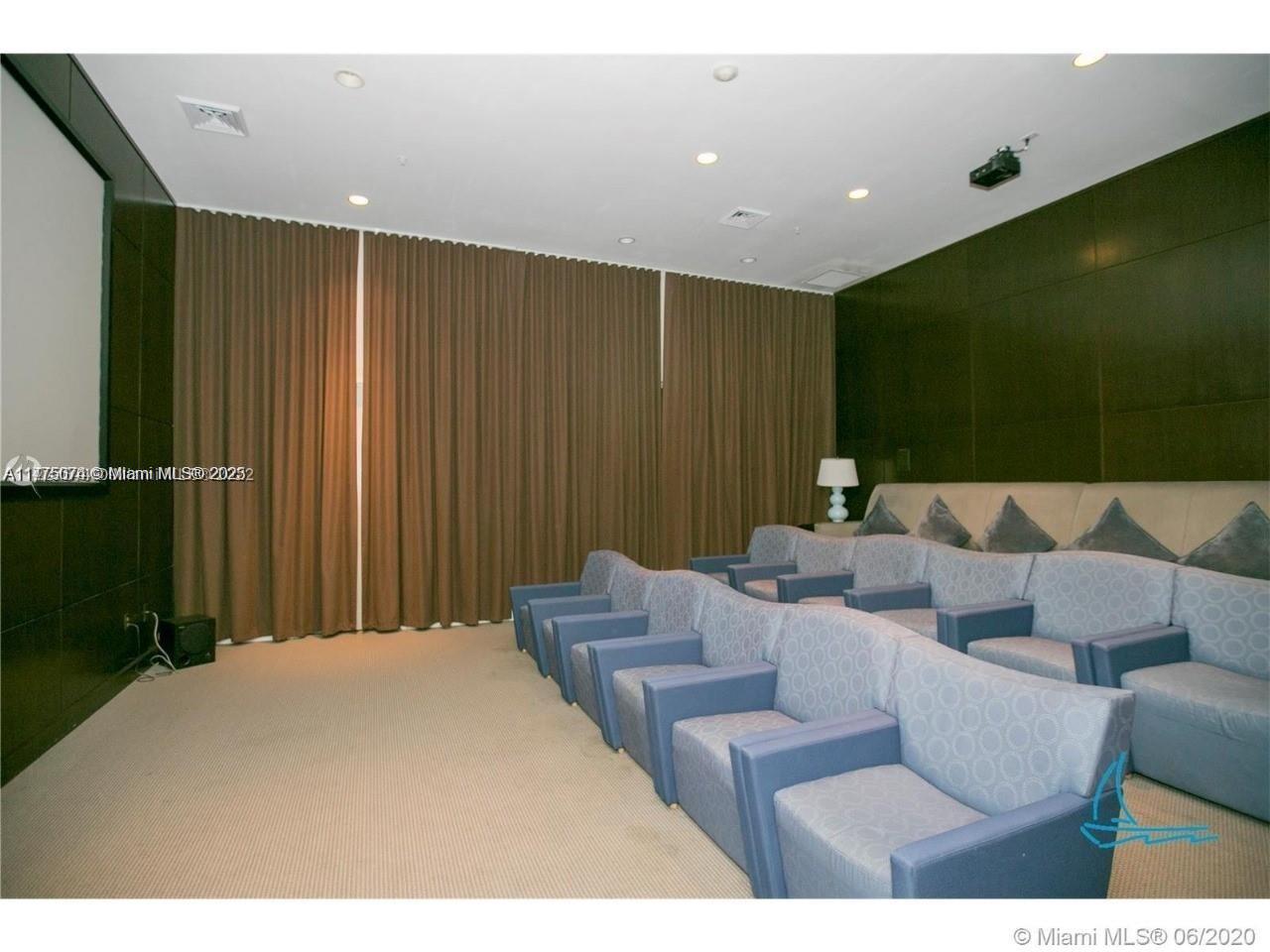 2775 Northeast 187th Street, Unit 326 Aventura, FL 33180 - Photo 23 of 23 a living room with furniture and a projector