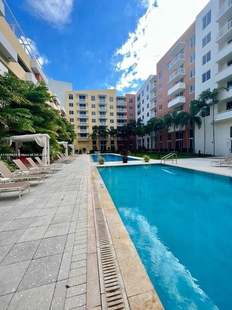 2775 Northeast 187th Street, Unit 326 Aventura, FL 33180 - Photo 6 of 23 a view of swimming pool with outdoor seating and plants