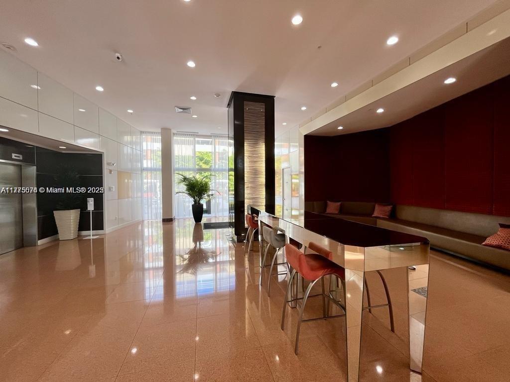 2775 Northeast 187th Street, Unit 326 Aventura, FL 33180 - Photo 9 of 23 a kitchen with stainless steel appliances a refrigerator and a kitchen island