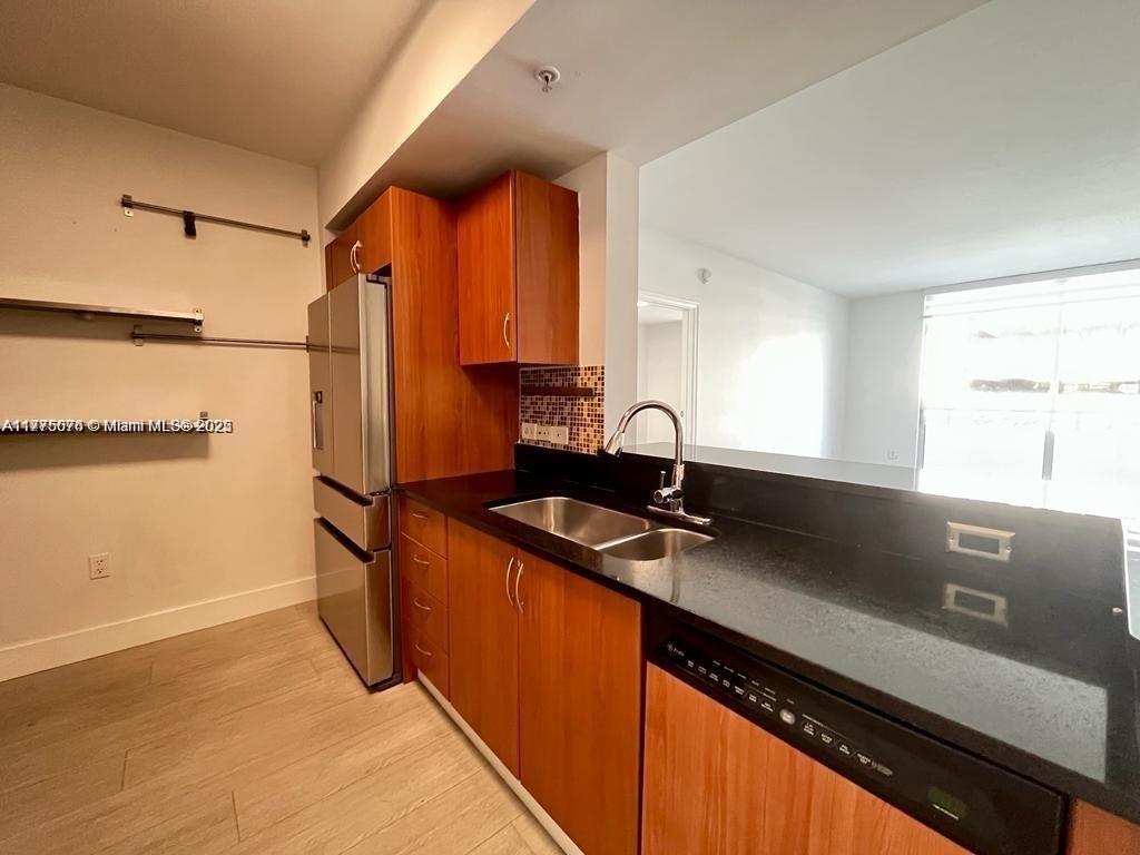 2775 Northeast 187th Street, Unit 326 Aventura, FL 33180 - Photo 10 of 23 a kitchen with stainless steel appliances granite countertop a sink stove and refrigerator