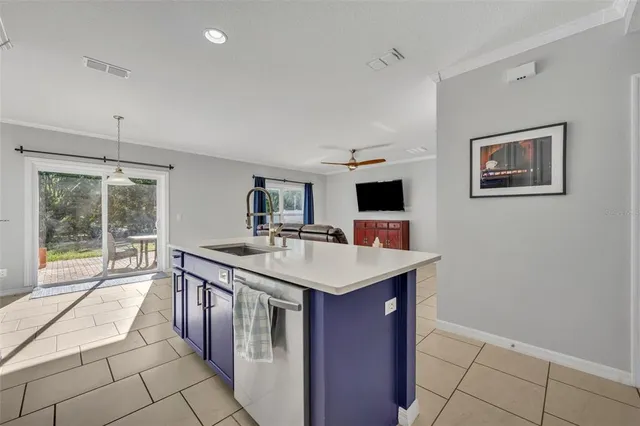 a kitchen with a sink stove and cabinets