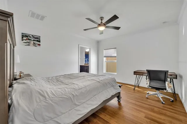 a bedroom with a bed and a chair