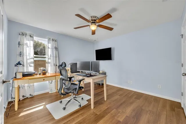a work room with wooden floor and a window