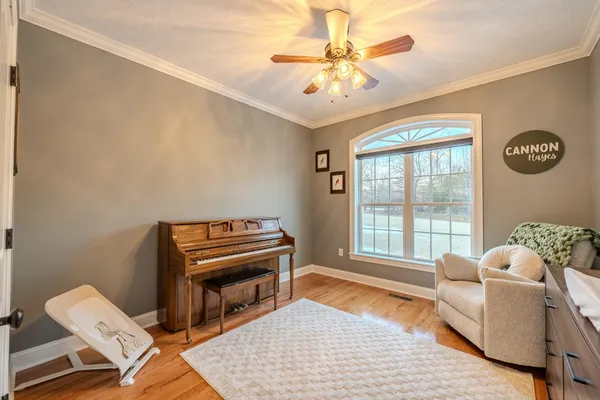 a living room with furniture and a chandelier
