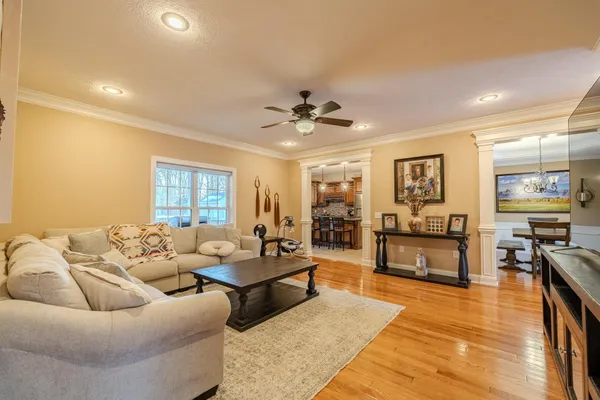 a living room with furniture and wooden floor