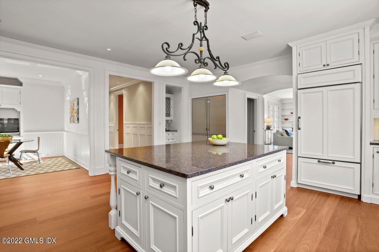 56 Frontier Road Cos Cob, CT 06807 - Photo 13 of 32 a kitchen with stainless steel appliances granite countertop a refrigerator a sink dishwasher a stove and white countertops with wooden floor