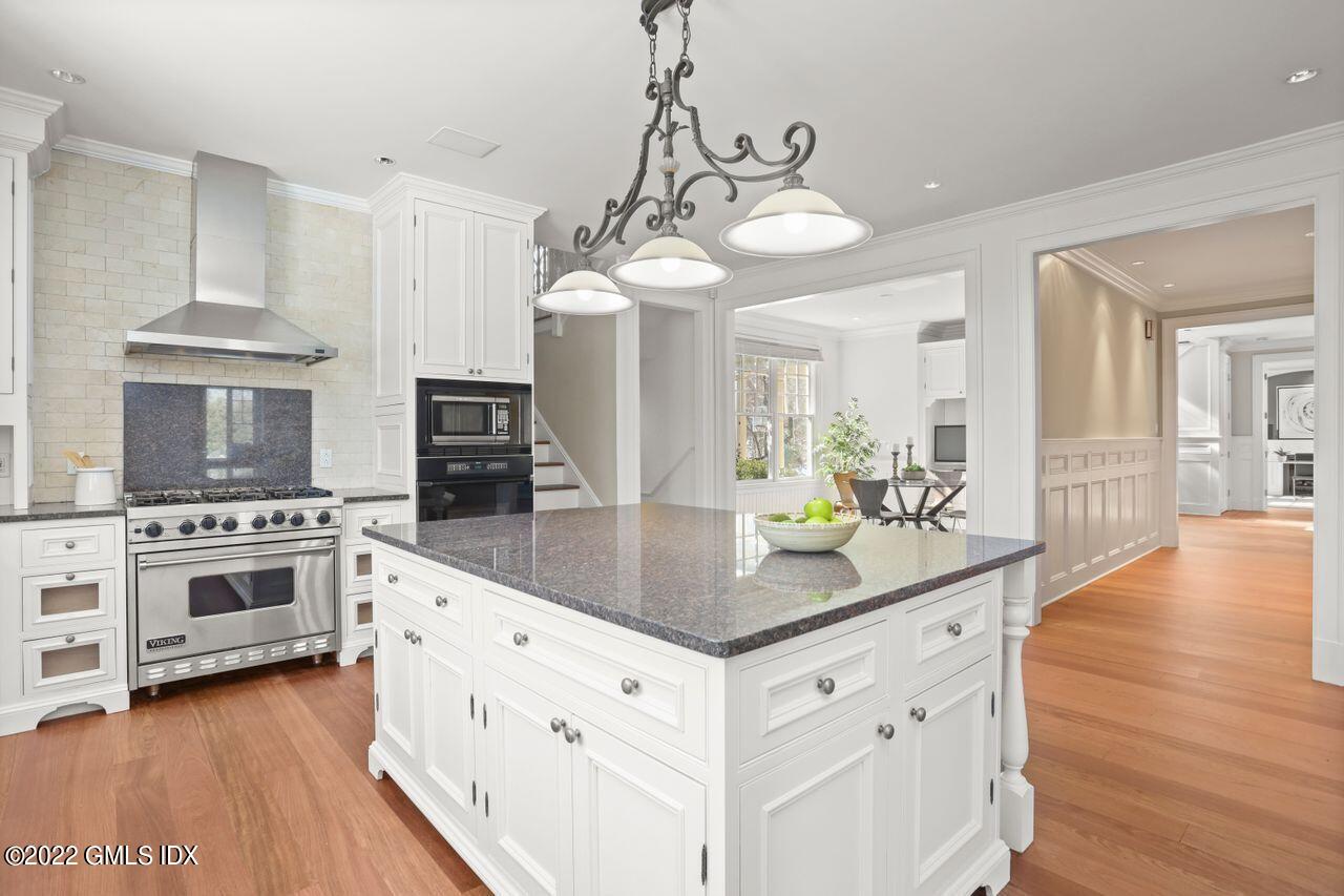 56 Frontier Road Cos Cob, CT 06807 - Photo 14 of 32 a kitchen with stainless steel appliances kitchen island granite countertop a stove a sink and a wooden floors