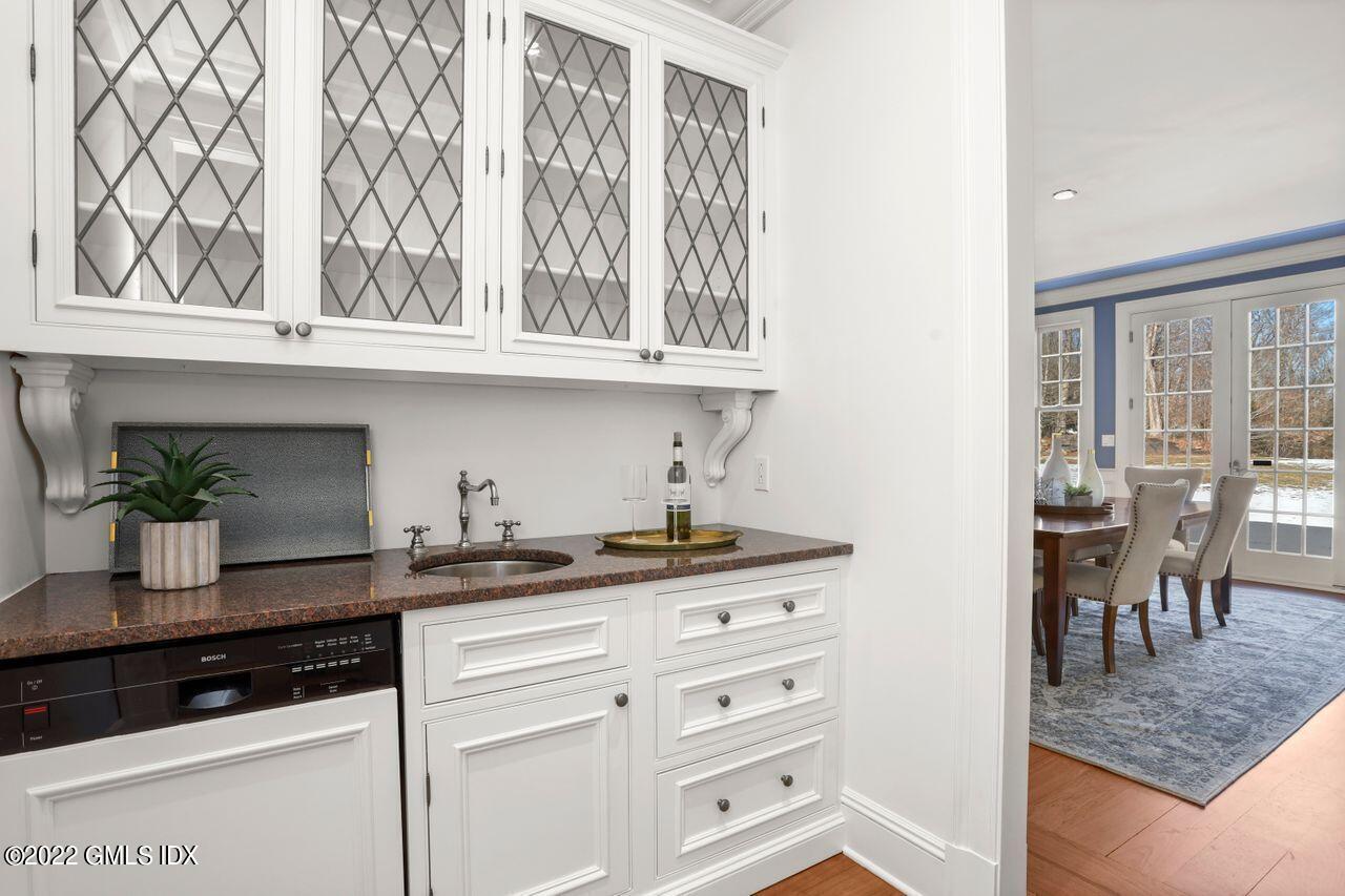 56 Frontier Road Cos Cob, CT 06807 - Photo 15 of 32 a kitchen with granite countertop a sink and cabinets