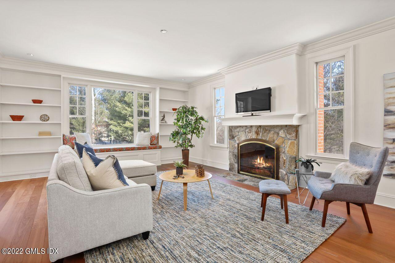 56 Frontier Road Cos Cob, CT 06807 - Photo 17 of 32 a living room with furniture and a fireplace