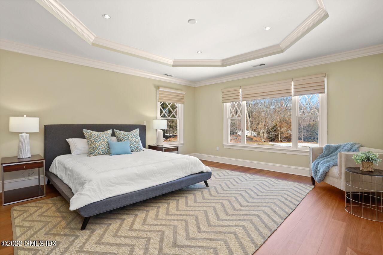 56 Frontier Road Cos Cob, CT 06807 - Photo 19 of 32 a bedroom with a large bed and a wooden floor
