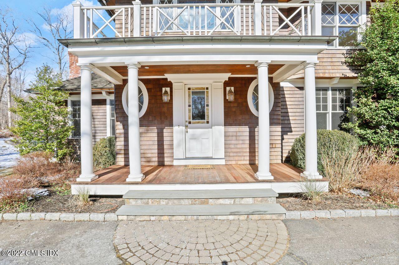 56 Frontier Road Cos Cob, CT 06807 - Photo 2 of 32 a front view of a house with a porch