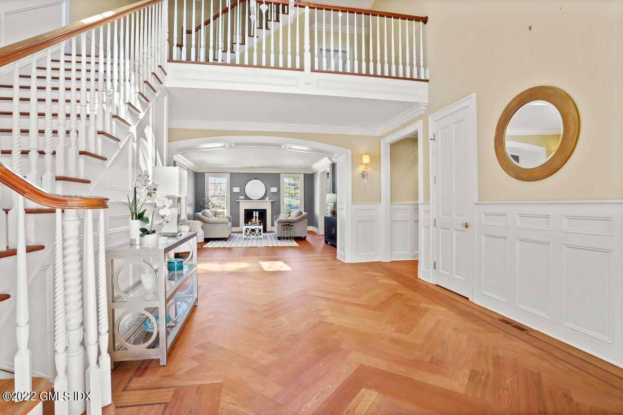 56 Frontier Road Cos Cob, CT 06807 - Photo 3 of 32 a view of a hallway with entryway wooden floor and front door