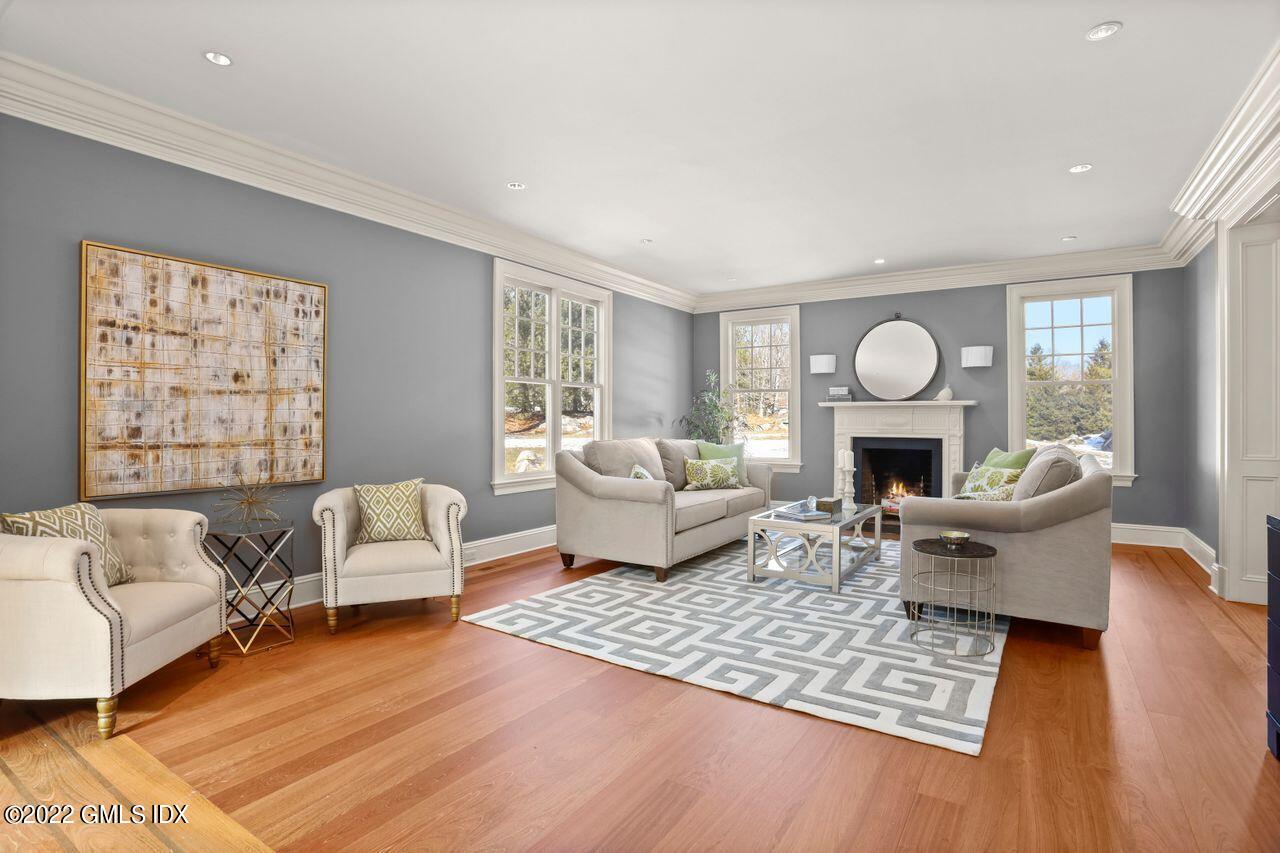 56 Frontier Road Cos Cob, CT 06807 - Photo 6 of 32 a living room with furniture and a fireplace