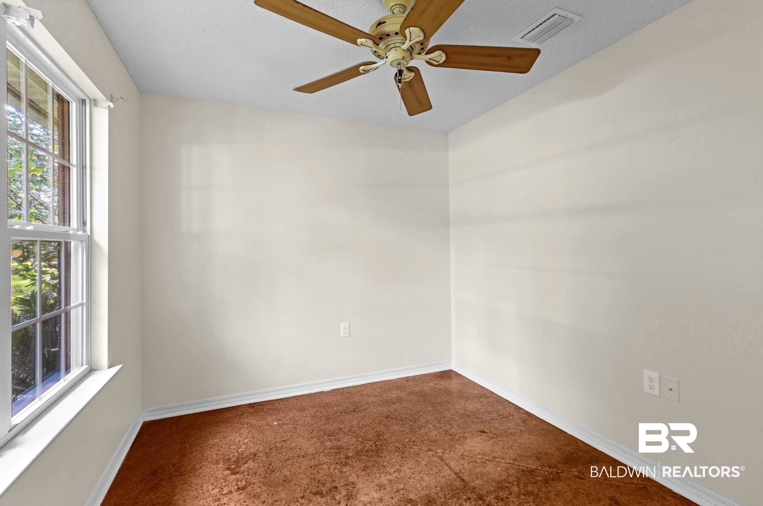 36087 Byrd Road Stapleton, AL 36578 - Photo 9 of 27 Unfurnished room featuring ceiling fan and dark colored carpet
