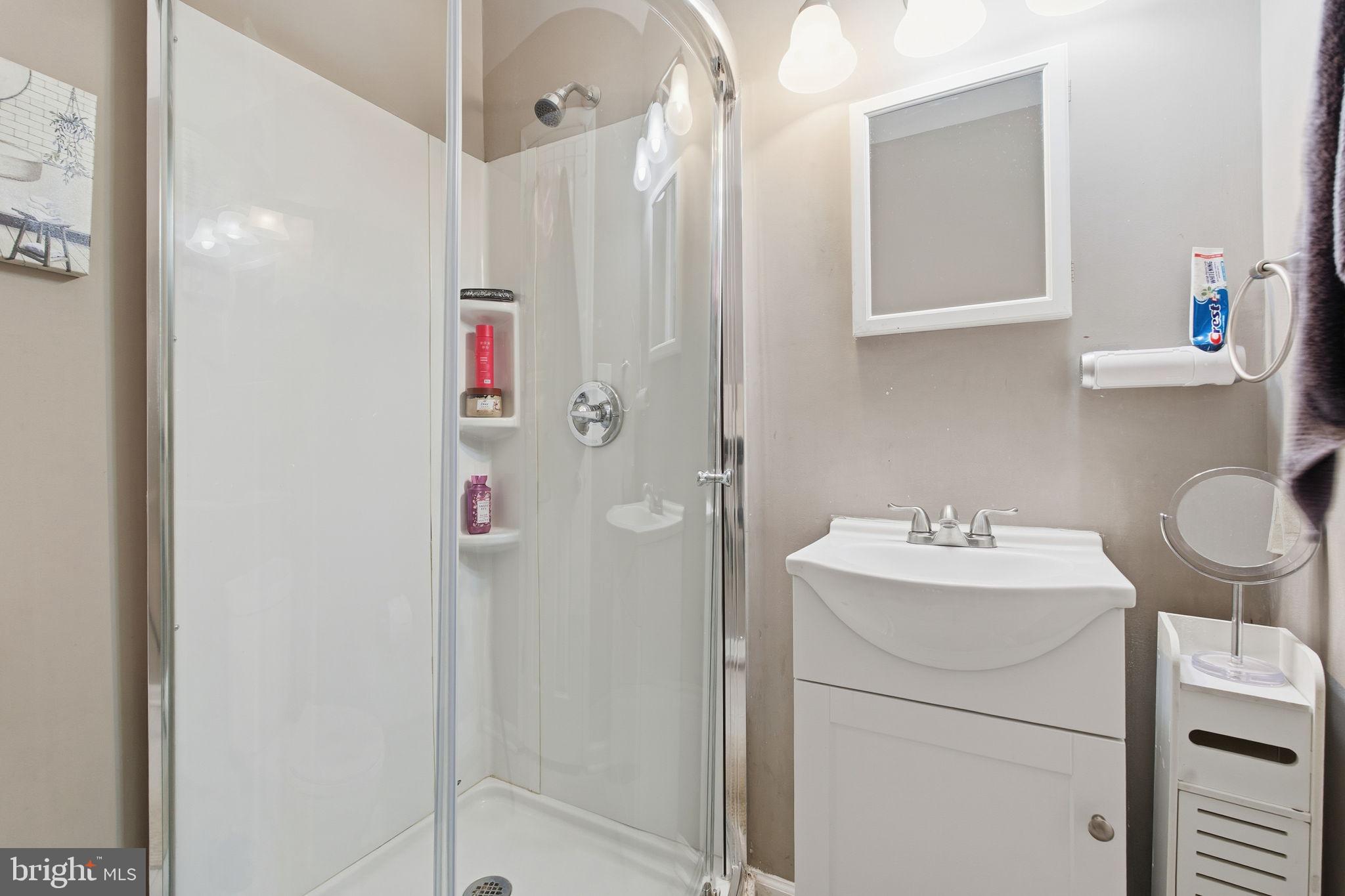620 Yorkshire Drive Edgewood, MD 21040 - Photo 16 of 31 a bathroom with a sink vanity mirror and shower