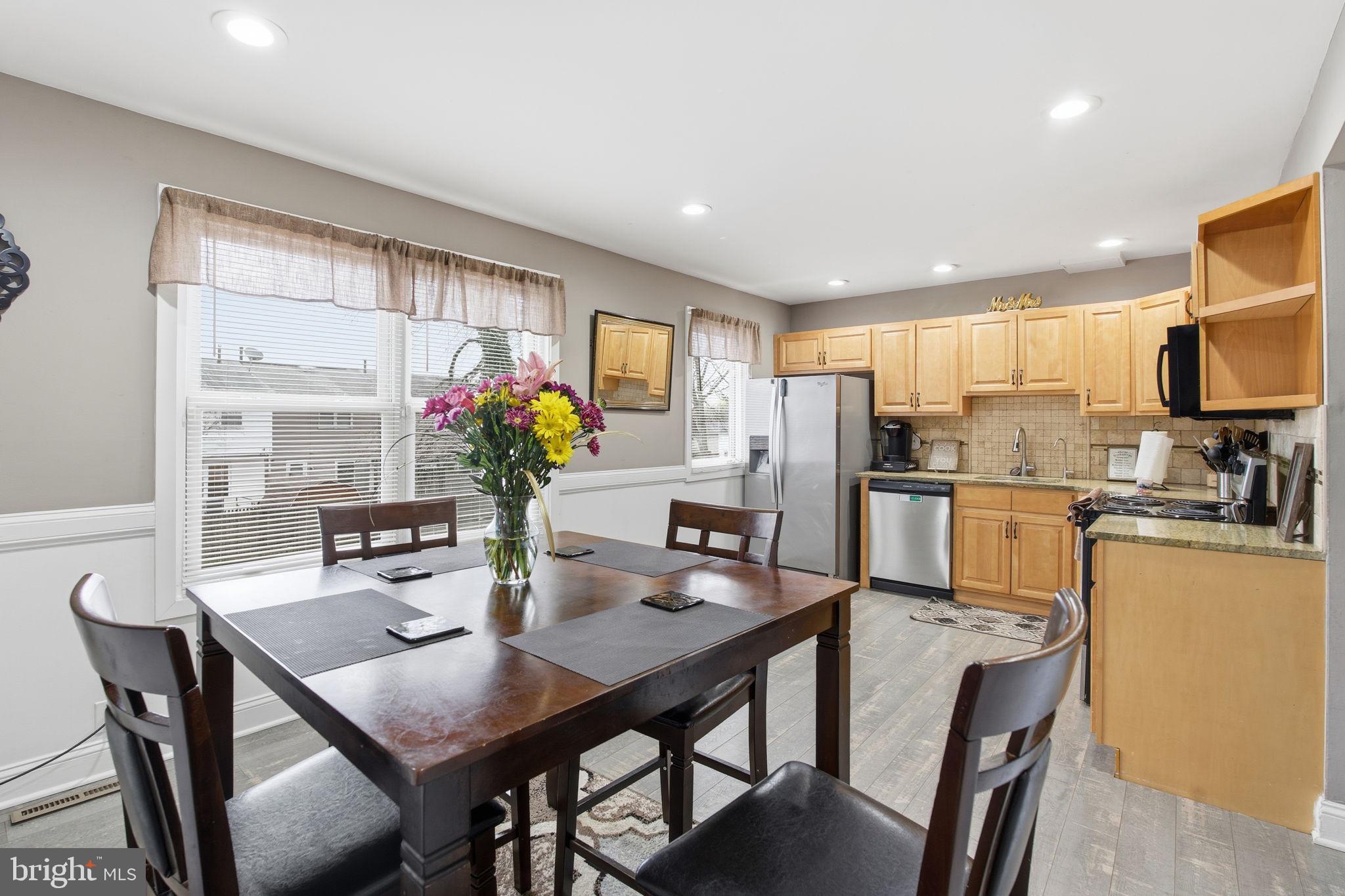 620 Yorkshire Drive Edgewood, MD 21040 - Photo 9 of 31 a kitchen with a dining table chairs and refrigerator