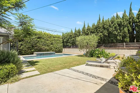 a view of a swimming pool with an outdoor space and seating area