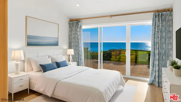 a bedroom with a large bed and a tv